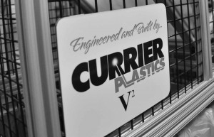 Machine guard with Sign that has Engineered and Built by Currier Plastics written on it