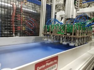 pick and place automation placing flip top caps on conveyor