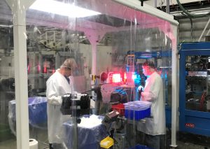 operators in portable clean room packing blow molded bottles