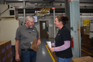 2 employees having a chat on injection molding floor.