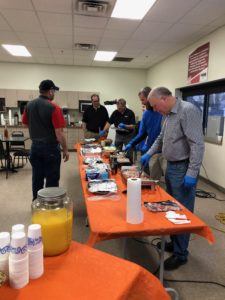 Employees enjoying a celebratory breakfast in cafeteria