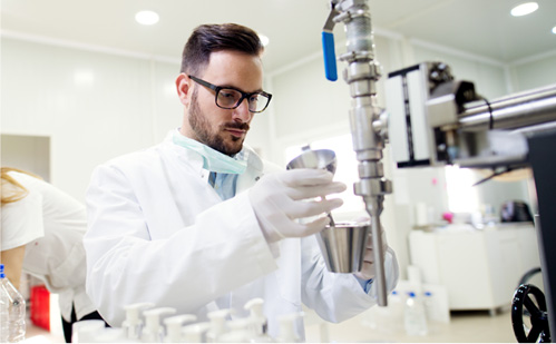 Male technician testing in laboratory in white coat